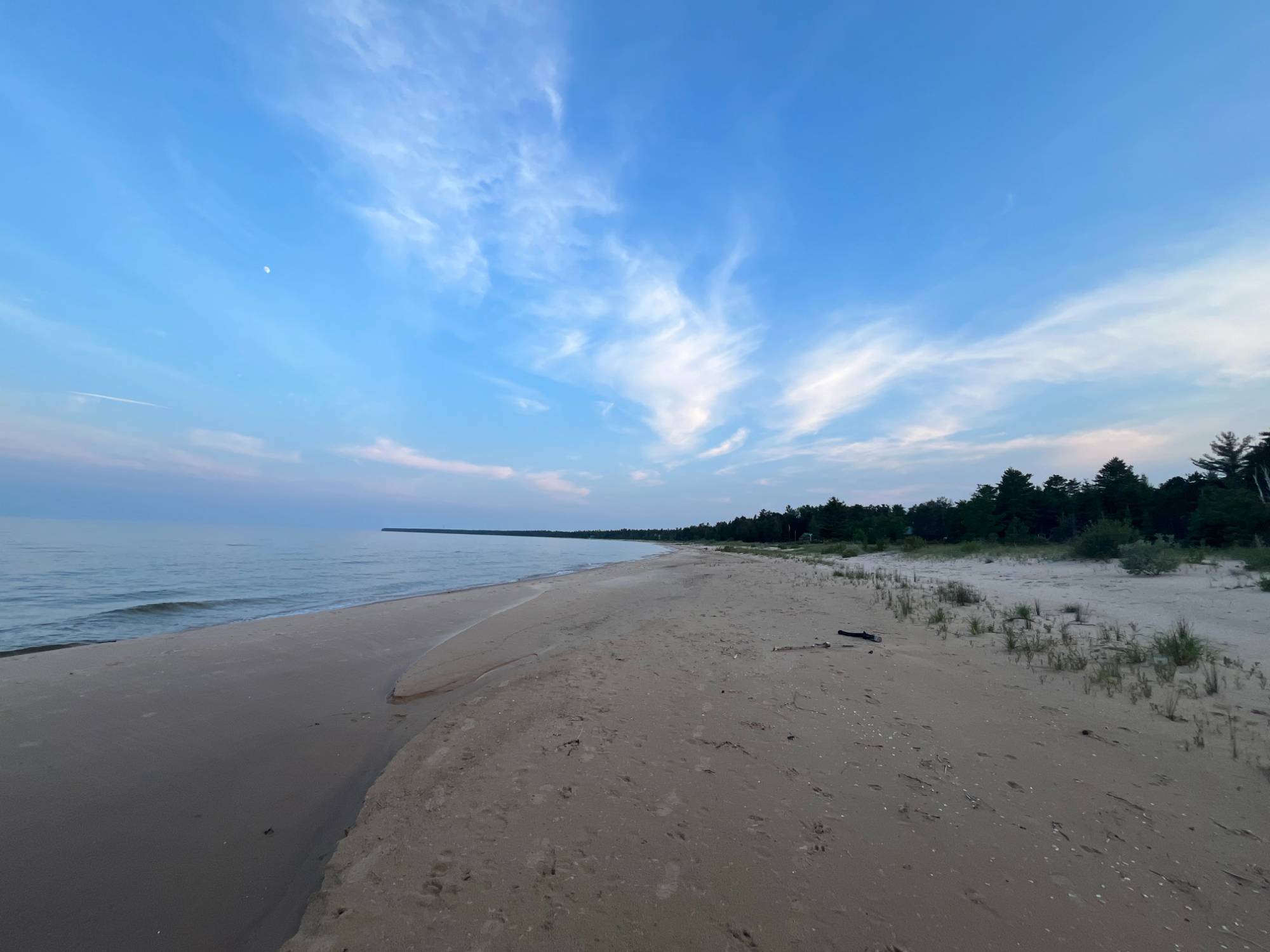 Sunset over Lake Michigan with a wooden dock in the forefront